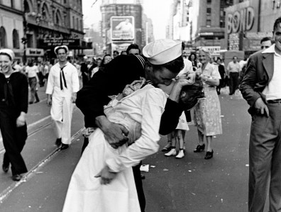 Happy sailor kissing nurse in Times Square during impromptu VJ Day celebration following announcement of the Japanese surrender and the end of WWII.